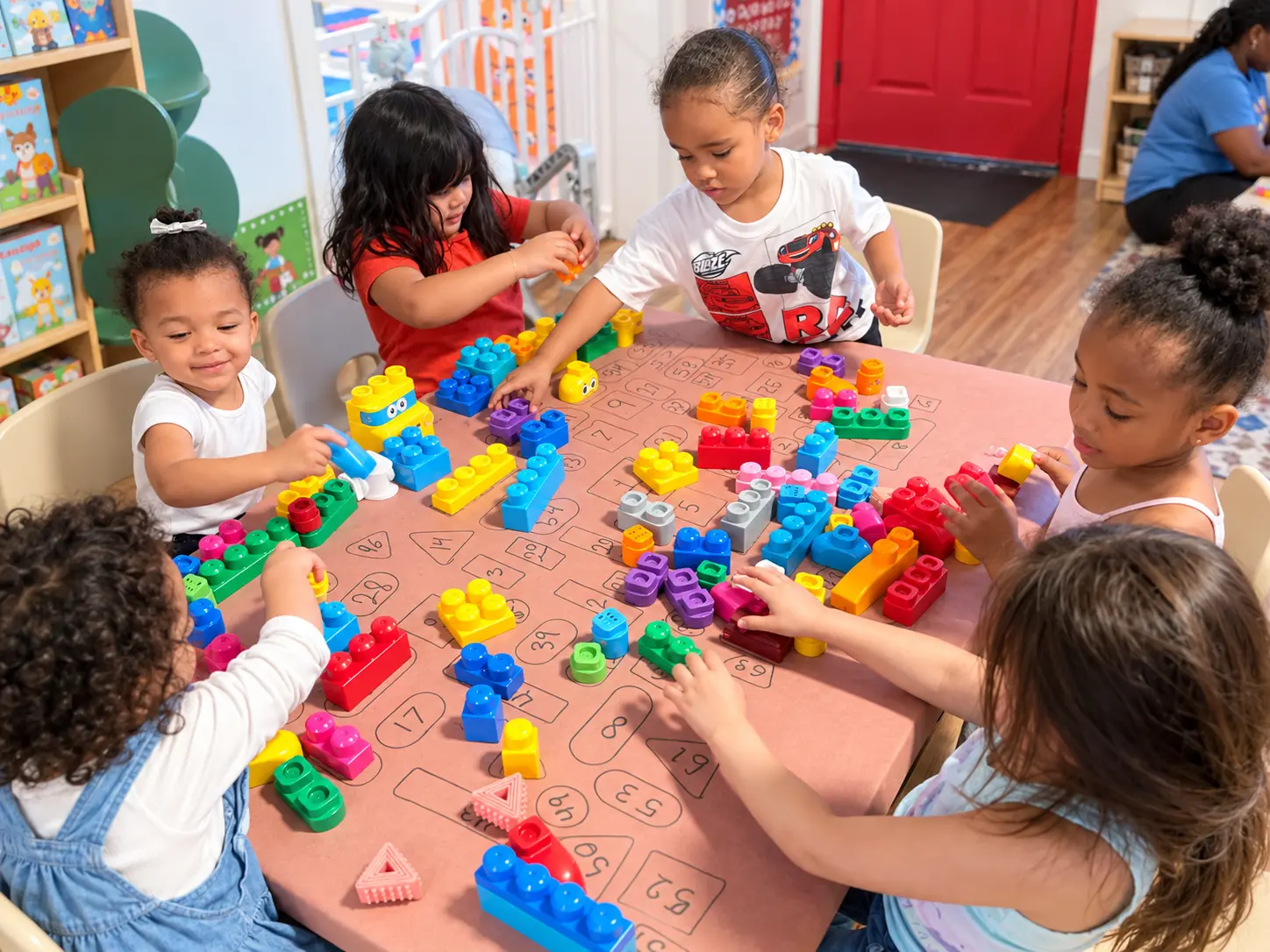 Preschool children building, counting, and learning together with colorful blocks