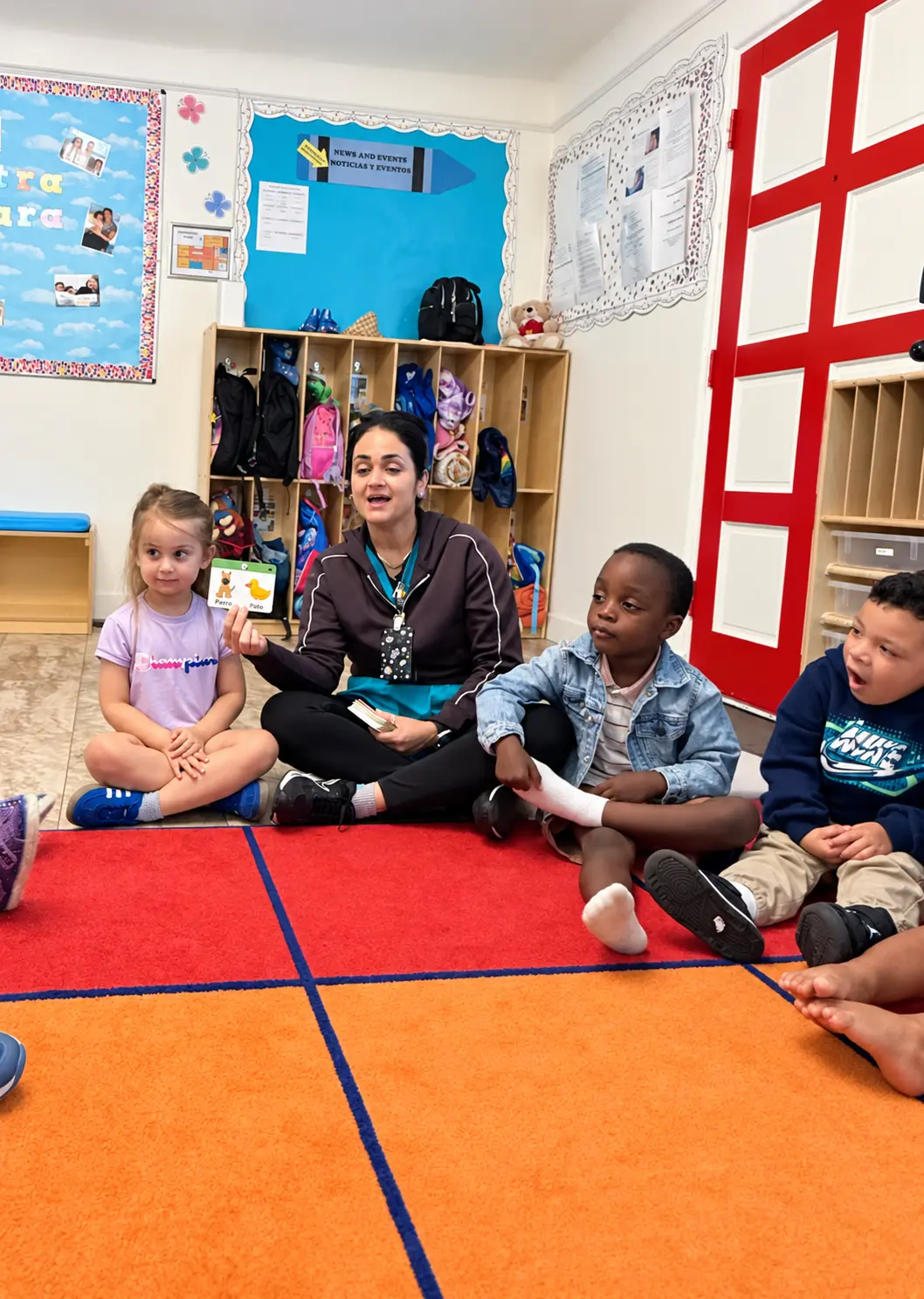 Toddlers participating in a bilingual classroom lesson with their teacher